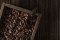 Rough wooden box with raw cocoa beans