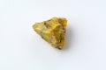 Rough yelow opal crystal, unpolished mineral. Close-up, white background