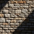 Roughly cut, rectangular stones varying in shades of beige and brown form a wall. The Royalty Free Stock Photo