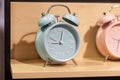 Round alarm clock on the store shelf close-up. Sale of various watches