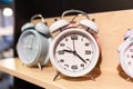 Round alarm clock on the store shelf close-up. Sale of various watches