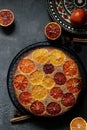 round appetizing bright orange orange pie on a dark gray table background