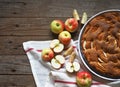 Round apple pie or biscuit on a white napkin with fresh pears on a wooden table