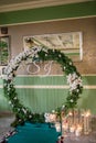 Round arch for the ceremony with candles the floor