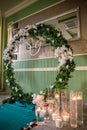 Round arch for the ceremony with candles the floor