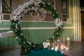 Round arch for the ceremony with candles the floor