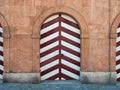 Ancient wooden doors in redbrown white stripes