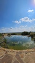 Round artificial pond with fish in the garden of a country house. Royalty Free Stock Photo