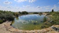 Round artificial pond with fish in the garden of a country house. Royalty Free Stock Photo