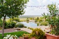 Round artificial pond with fish in the garden of a country house. Royalty Free Stock Photo