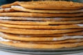 Round baked cake layers stacked on a plate