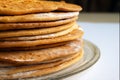 Round baked cake layers stacked on a plate