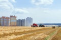A round baler discharges a fresh wheat bale Royalty Free Stock Photo