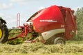 A round baler making hay bale bales during harvesting