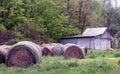 Round bales of hay and grey barn Royalty Free Stock Photo