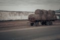 Round bales of hay are loaded onto a tractor trailer Royalty Free Stock Photo