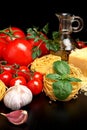 Round balls of pasta with cheese, tomatoes,basil,olive oil on black Royalty Free Stock Photo