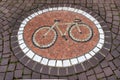 Round bicycle mosaic in a sidewalk of cobblestones. Bicycle mosaic on a sidewalk