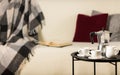 Round black metal coffee table with a coffee maker and a cup on