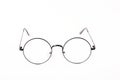 Round black-rimmed glasses are located frontally on a white background.