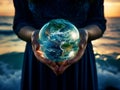 Round blue planet Earth with continents in caring female hands