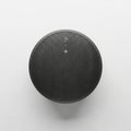 Round Bluetooth speaker with a black mesh grill set against a white background Royalty Free Stock Photo