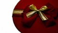 Round box. Top view of the burgundy box with a red-gold bow. a gift with a red ribbon on the lid. Holidays concept Royalty Free Stock Photo