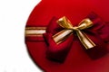 Round box. Top view of the box with a red-gold bow. a gift with a red ribbon on the lid. Holidays concept Royalty Free Stock Photo