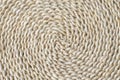 Round braided natural staw table mat texture. Full frame of tightly woven straw pattern