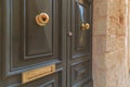 Round brass knob, keyhole, hole for letters, on luxurious doors