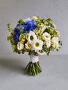 Round bridal wedding bouquet on gray concrete background. The wedding bouquet consists of freesia, Matthiola, lisianthus, dianthus