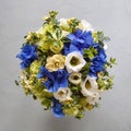 Round bridal wedding bouquet on a gray concrete background. The wedding bouquet consists of freesia, Matthiola, lisianthus,