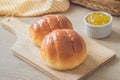 Round bun, bread rolls on wooden plate and pineapple jam Royalty Free Stock Photo