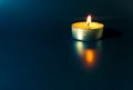 a round candle burns on a blue background