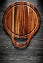 Round carving board on wood background Royalty Free Stock Photo