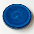 Round ceramic object with a smooth, glossy finish in a deep blue color. The surface Royalty Free Stock Photo