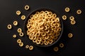round cereal cornflakes in black bowl isolated on black background view from top Royalty Free Stock Photo