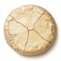 A round cheese wheel with a cracked surface, showcasing its natural texture Royalty Free Stock Photo