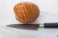 Round chicken smoked sausage, kitchen knife on cutting board