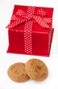 Round chocolate cookie and red gift box with bow Royalty Free Stock Photo