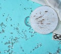 round chopping board on a green background