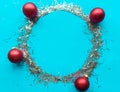 Round Christmas tinsel silver frame with red baubles. Xmas greeting card. Royalty Free Stock Photo