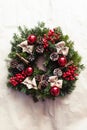 Round Christmas wreath with red baubles and berries Royalty Free Stock Photo