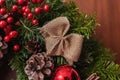 Round Christmas wreath with red baubles and berries Royalty Free Stock Photo