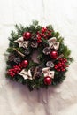 Round Christmas wreath with red baubles and berries Royalty Free Stock Photo