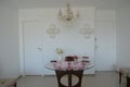 Round clear glass table with cake and sweets on it, decorated with pink acrylic stones