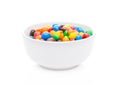 Round colorful coated sweet candies in white bowl