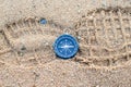 Round compass on sand footmark