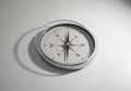 Round compass with a silver metallic rim and a white face, Royalty Free Stock Photo