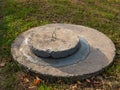Round concrete manhole on a concrete base. City sewerage system. A concrete manhole covers the entrance to the city